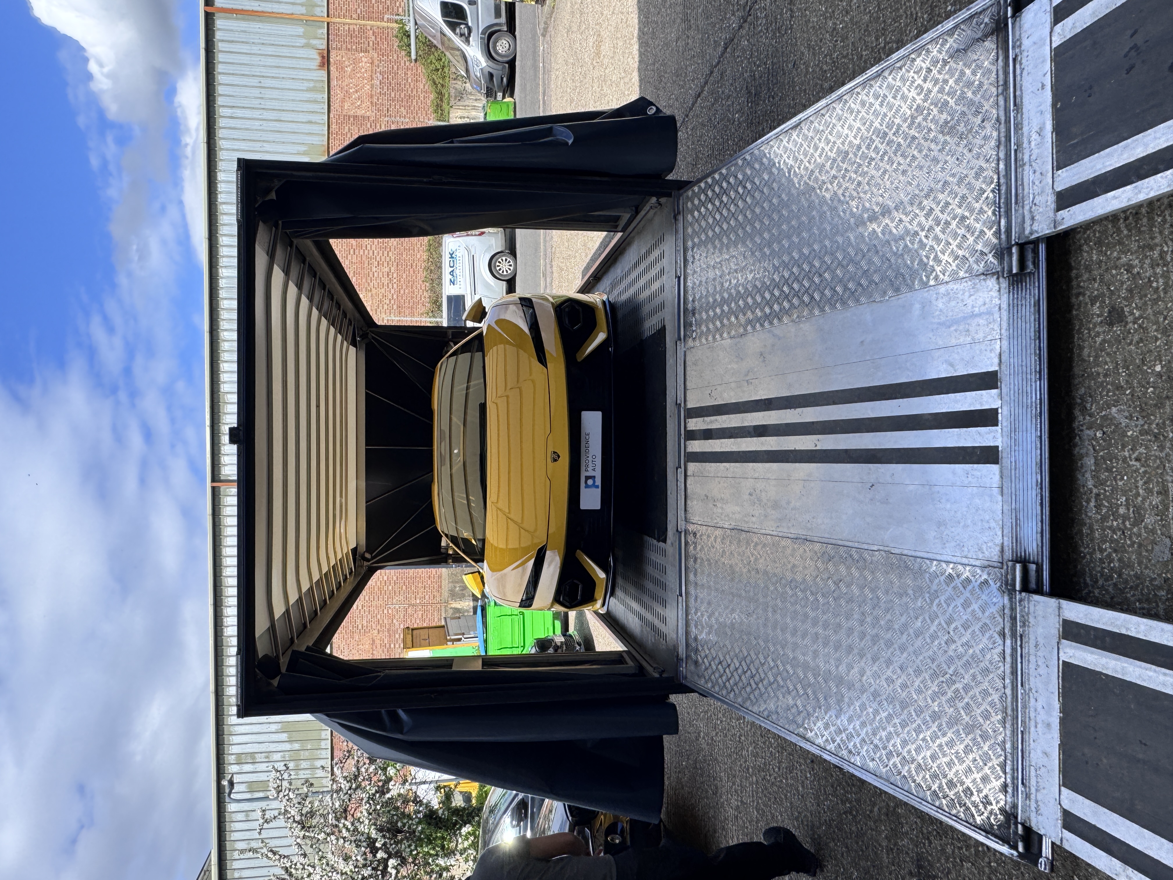 Vehicles being loaded into a shipping container